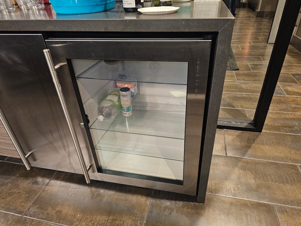 Compact countertop refrigerator installed beneath marble countertop