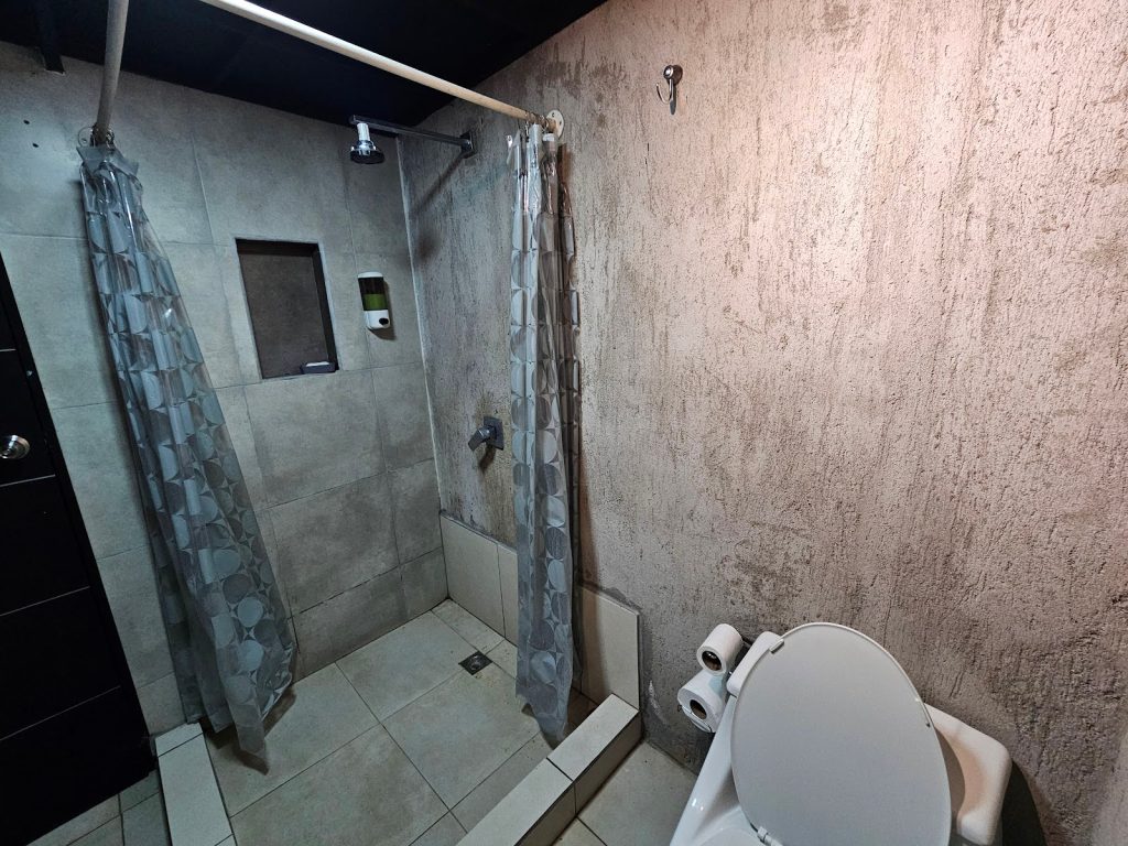 Cement finished bathroom walls with modern fixtures