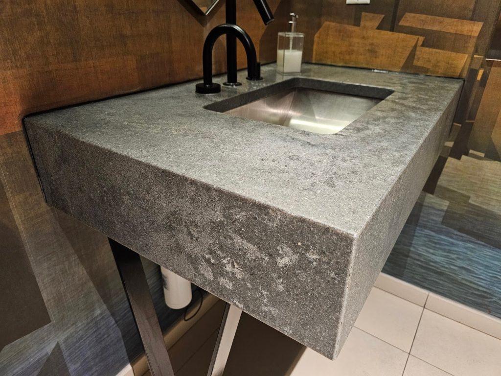 Modern bathroom showcasing dramatic lighting and shadow balance