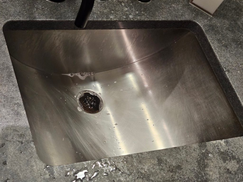 sink bowl is made with a contoured stainless steel