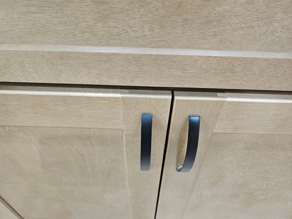 Kitchen renovation featuring natural wood grain shaker style cabinets and stone countertops