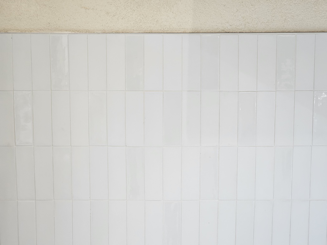 wall tile is only installed up to a height just above a typical chair rail