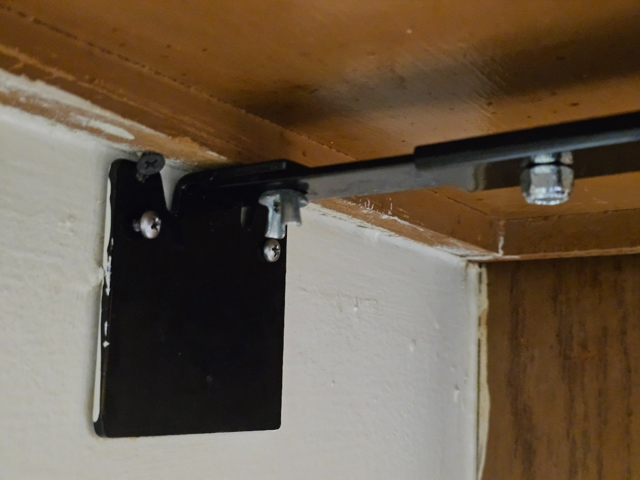 mounting bracket is mounted to the back wall of the kitchen
