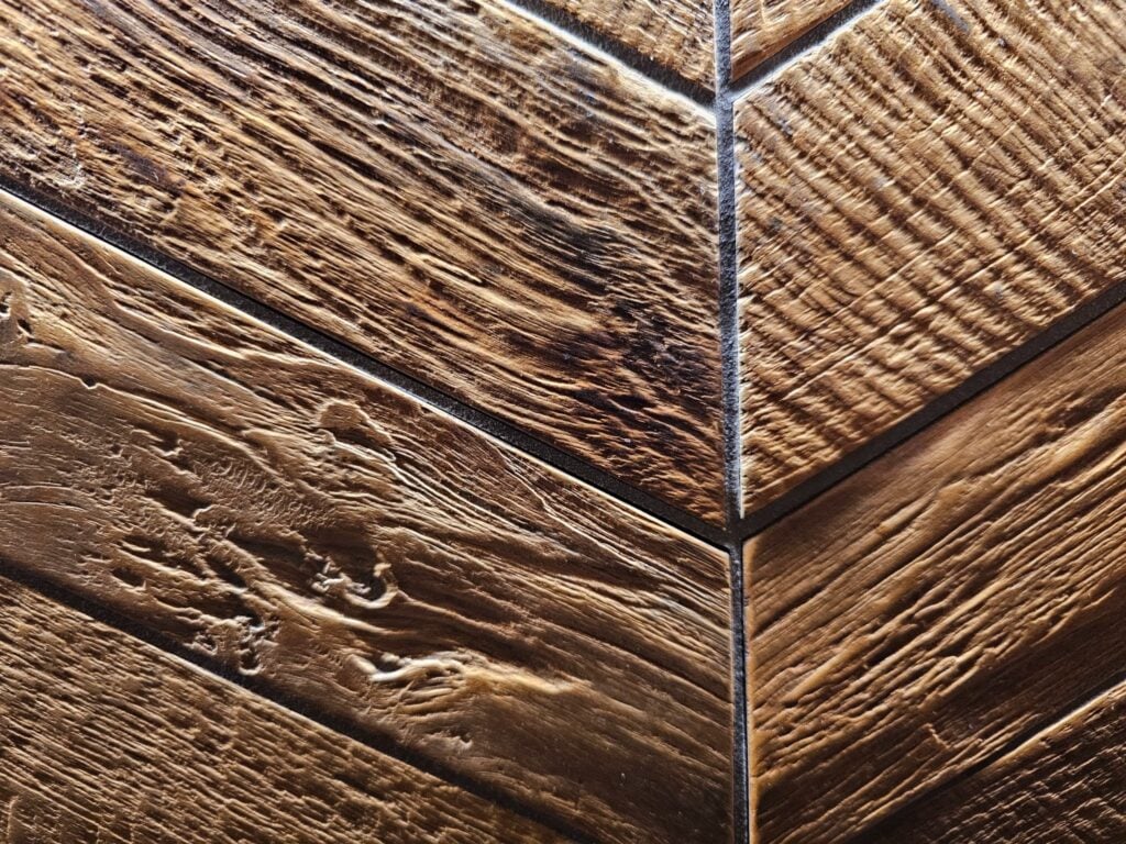 Close-up of wood-look porcelain tiles arranged in a herringbone pattern