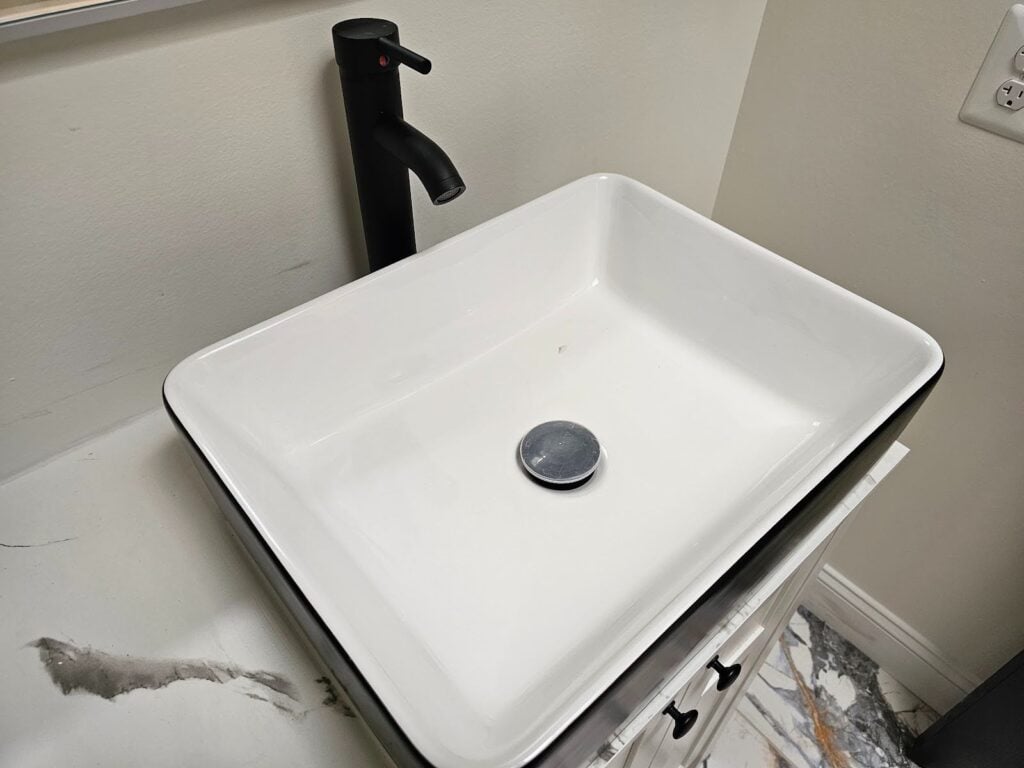 Black and white bathroom vanity makeover showcasing timeless contrast and functional organization