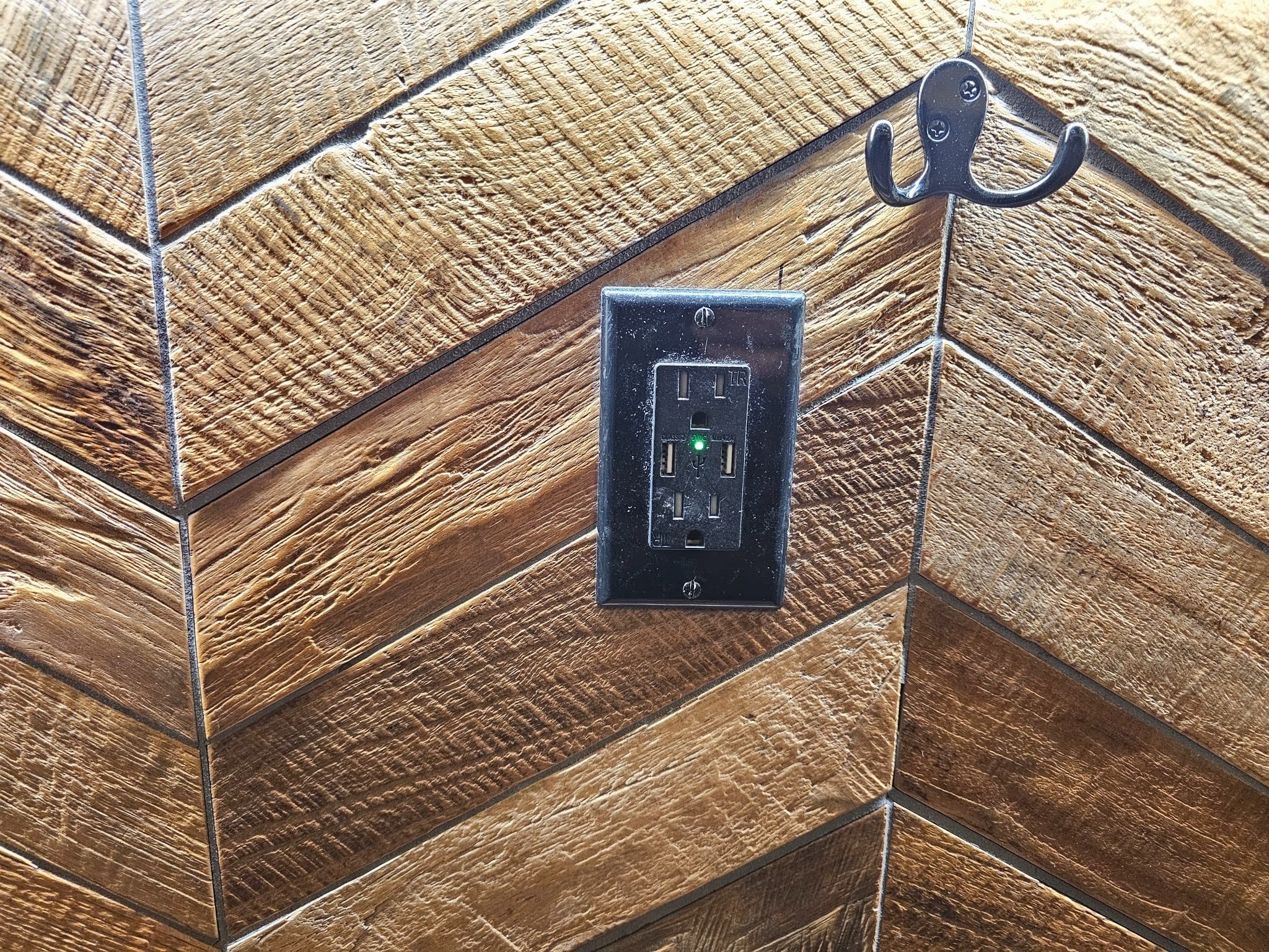 Herringbone pattern wood-like tile flooring installed in a modern residential space