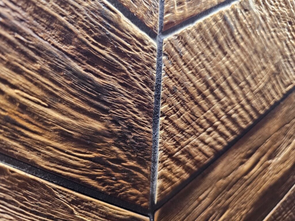 Professional installation of herringbone wood-like tile with precision alignment
