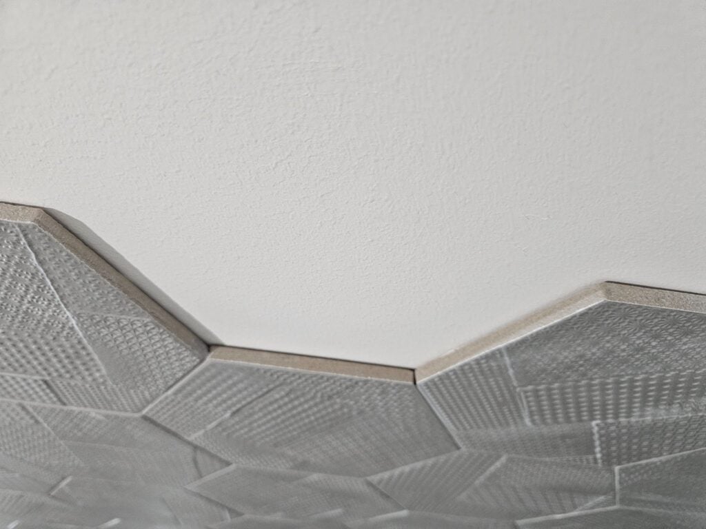 Professionally installed hex wall tiles with precise grout lines