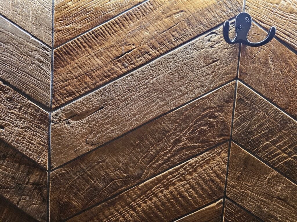 Wood-look herringbone tile flooring adding warmth and style to a renovated home