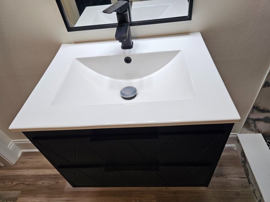 dark black or brown cabinet at the vanity base with a bright white countertop
